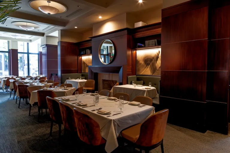 Dining room at Johnny Delmonico's with the fireplace surround, built-in shelving and booth seating